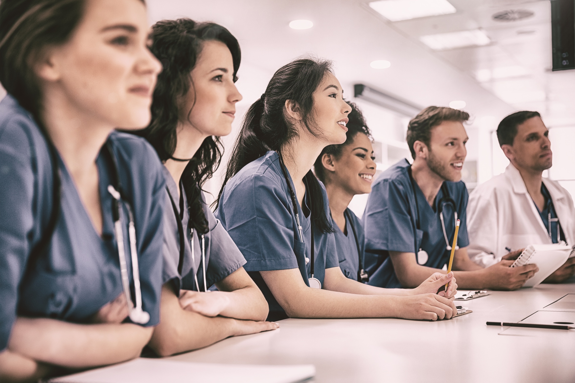 Medical students listening sitting at desk HC Skills International  Clinical Education Postgraduate Diploma course Leeds 