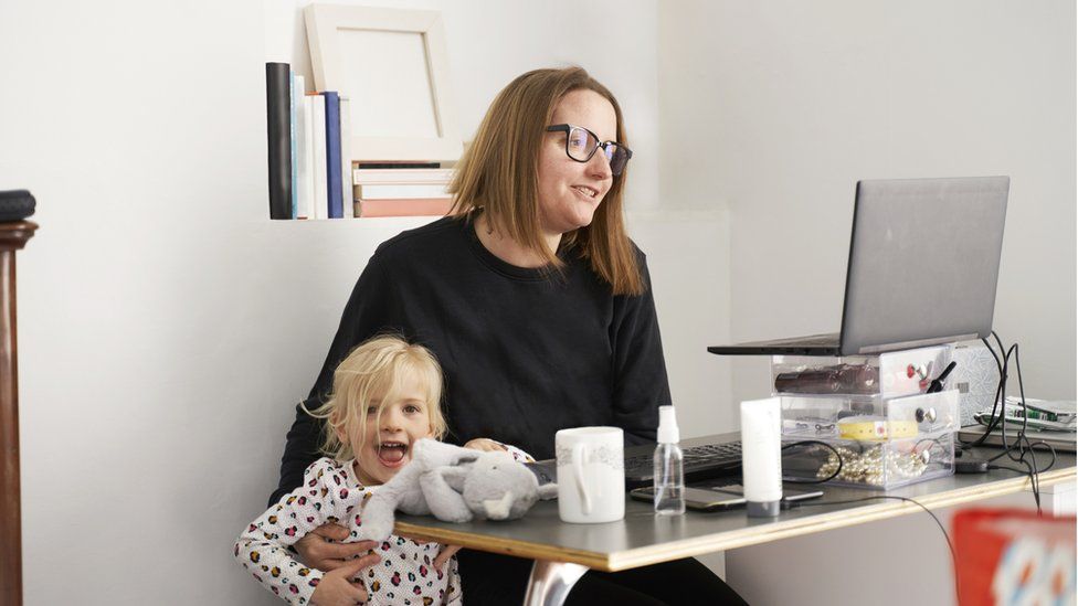 Woman trying to work from home with small child