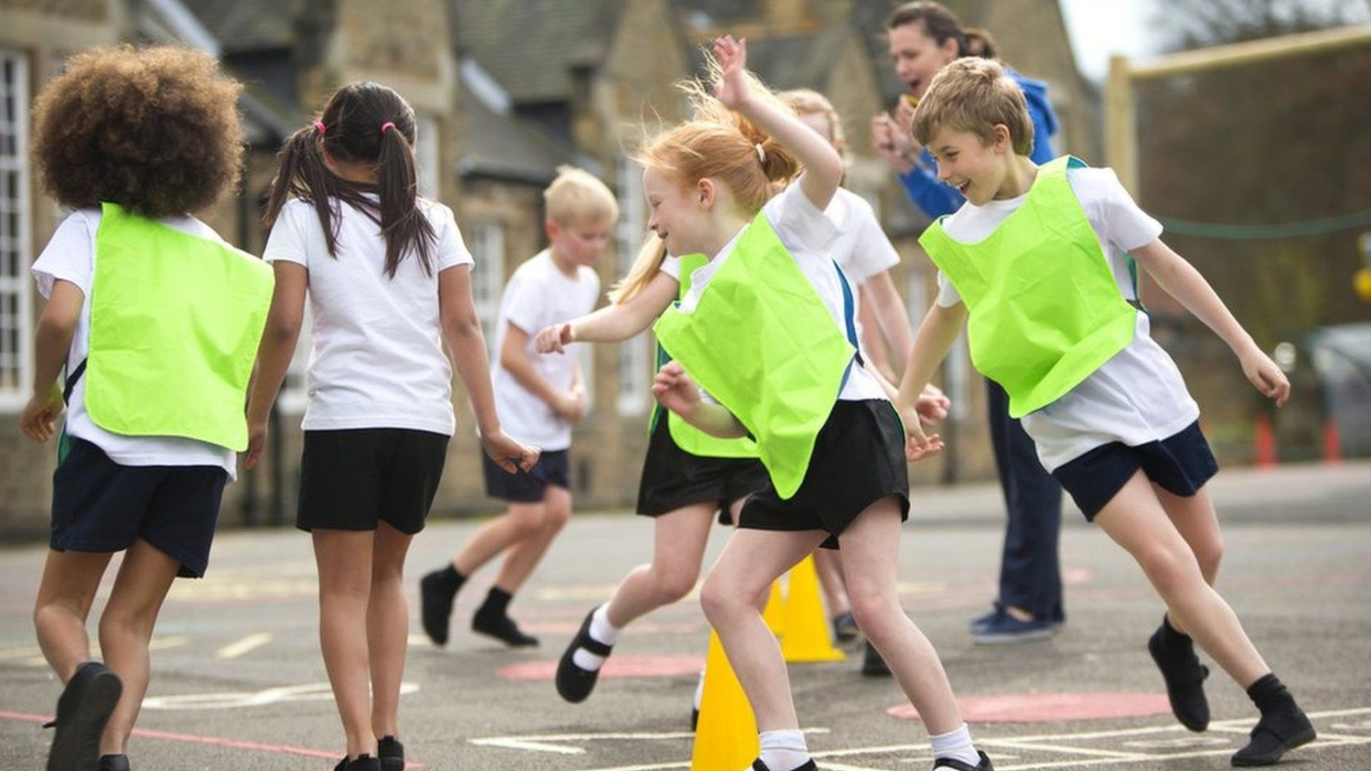 Primary school children doing exercise in the playground
