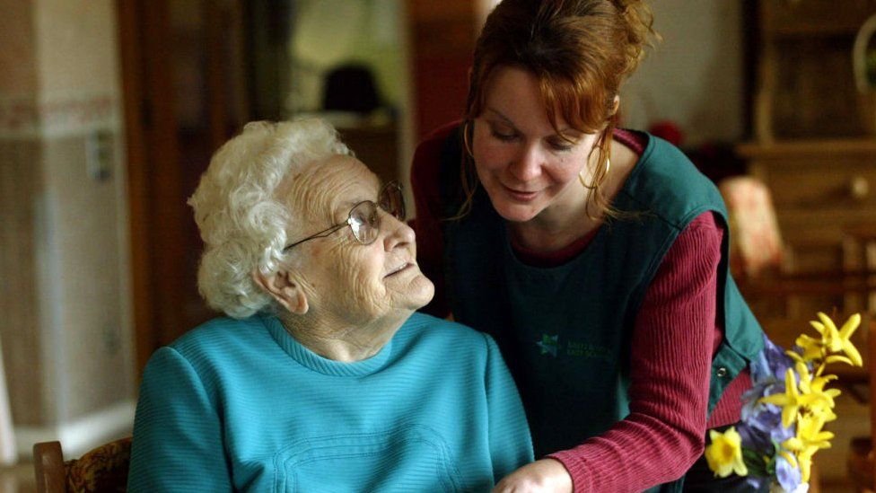A resident and a care assistant at a home in Bath