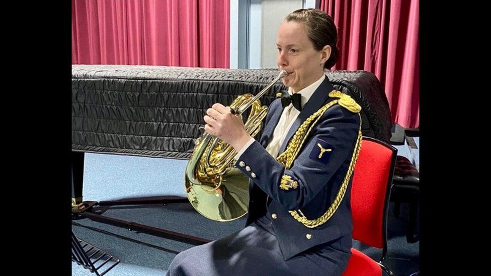 Shona Brownlee playing the French horn in her RAF uniform