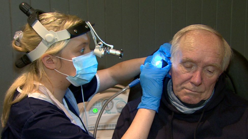 Cavan Granleese having wax removed from his ear at an opticians