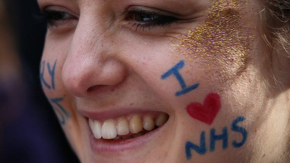Woman with I love NHS written on her face