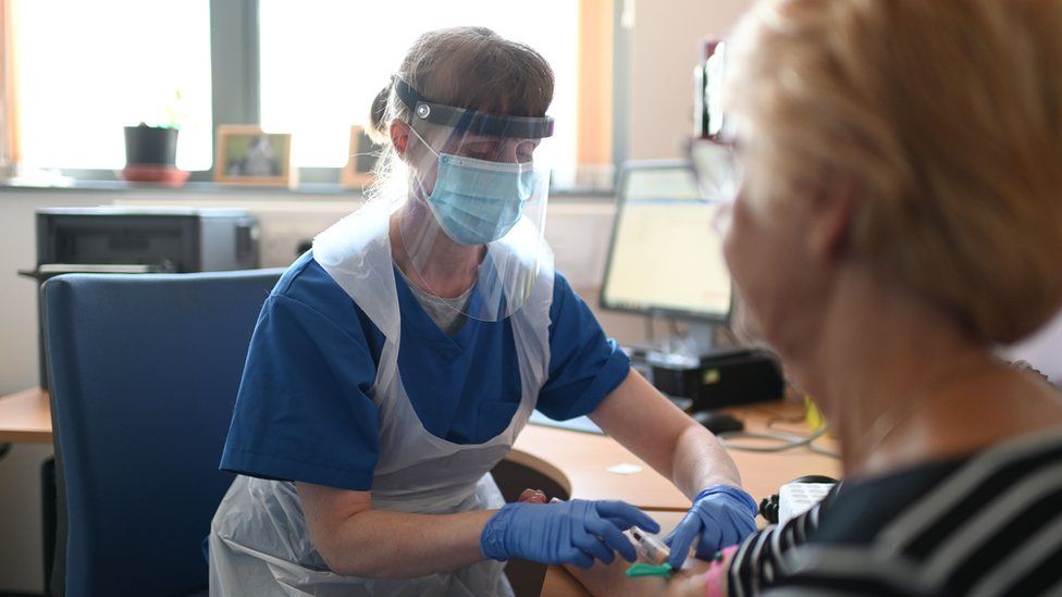 A nurse wears personal protective equipment