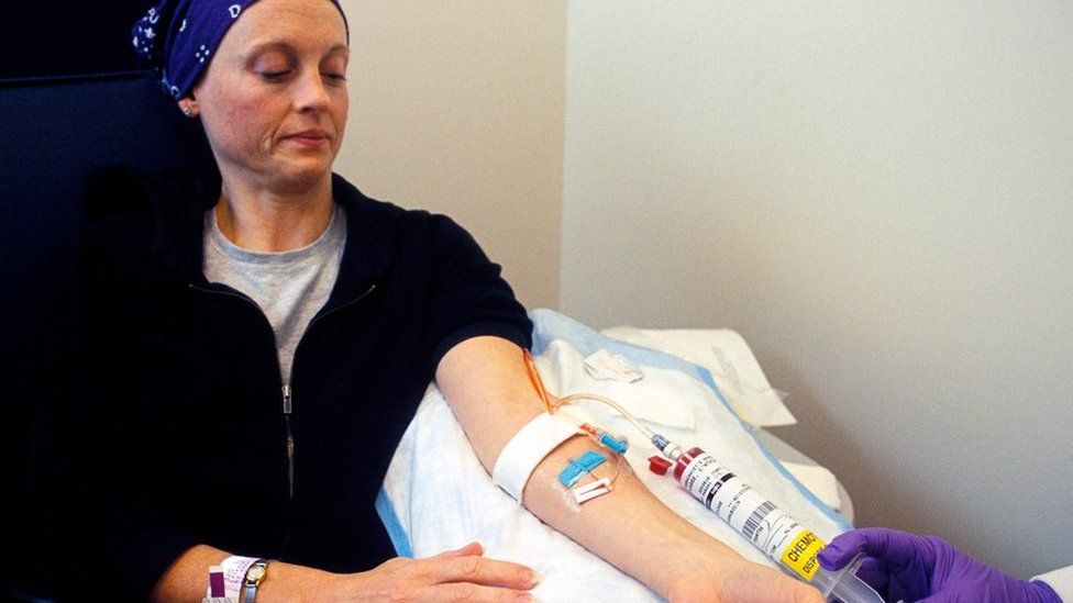 Cancer drugs are injected into a woman