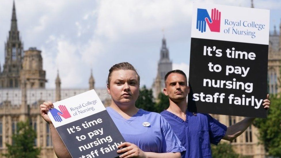 Nurses with placards outside the Royal College of Nursing (RCN) in Victoria Tower Gardens, London