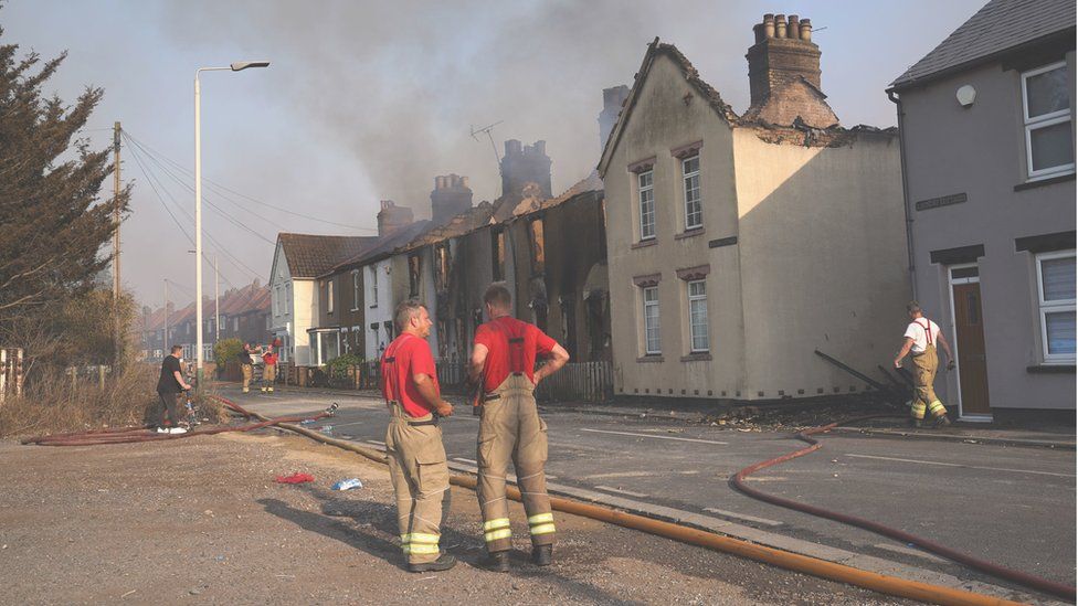 Firefighters at the scene of a fire in the village of Wennington, east London, in July 2022