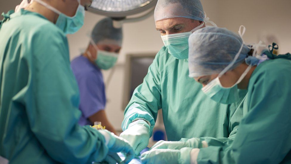 Hospital staff performing surgery