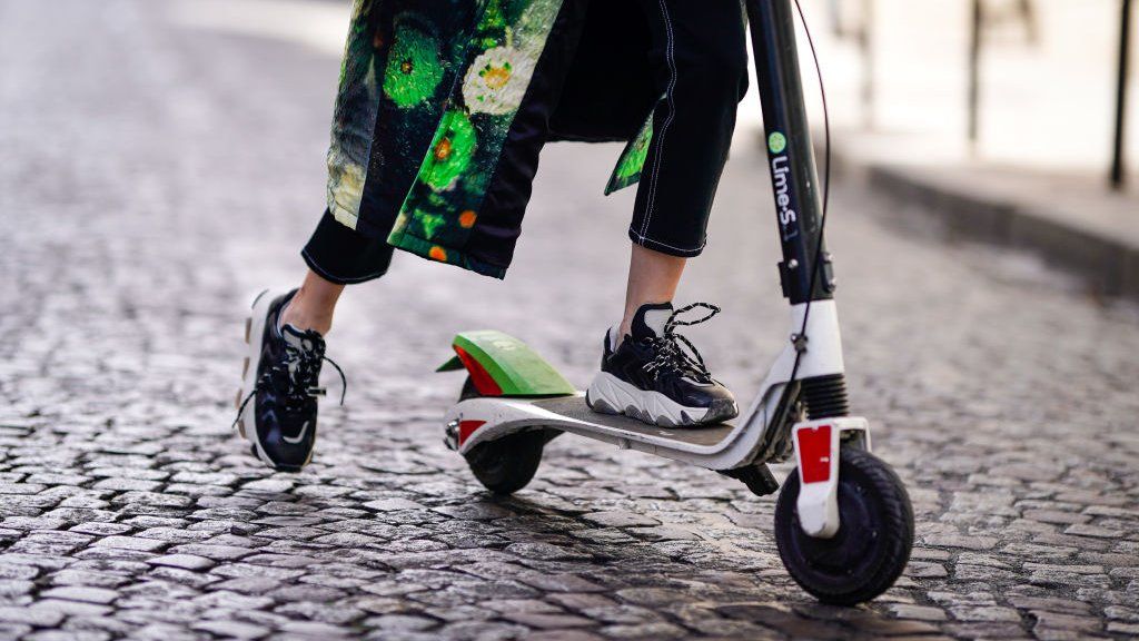 Woman using e-scooter in Paris