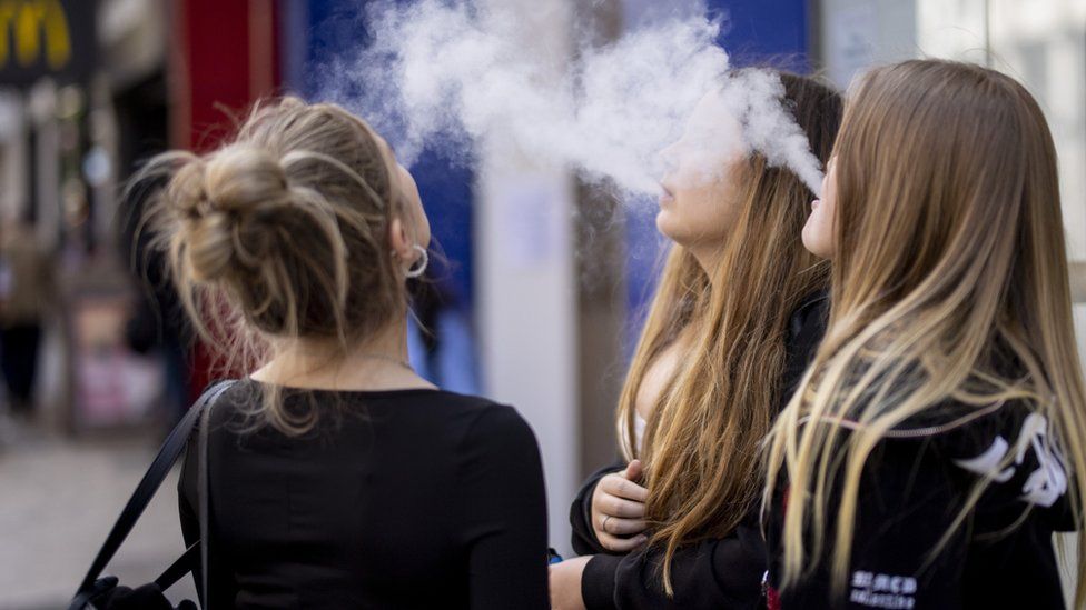 A group of young girls vaping