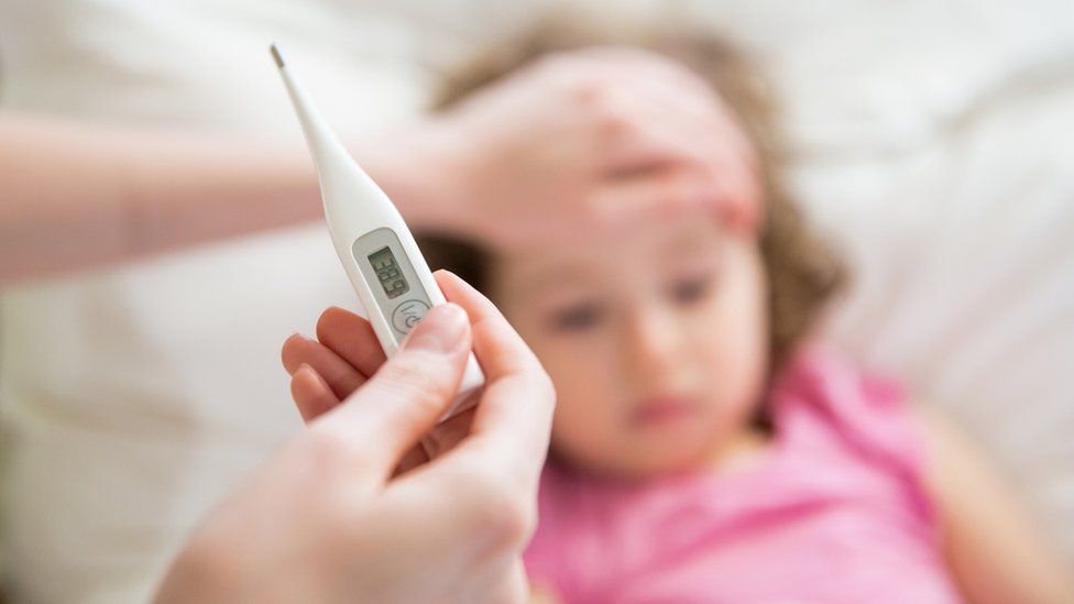 Parent monitoring child's temperature
